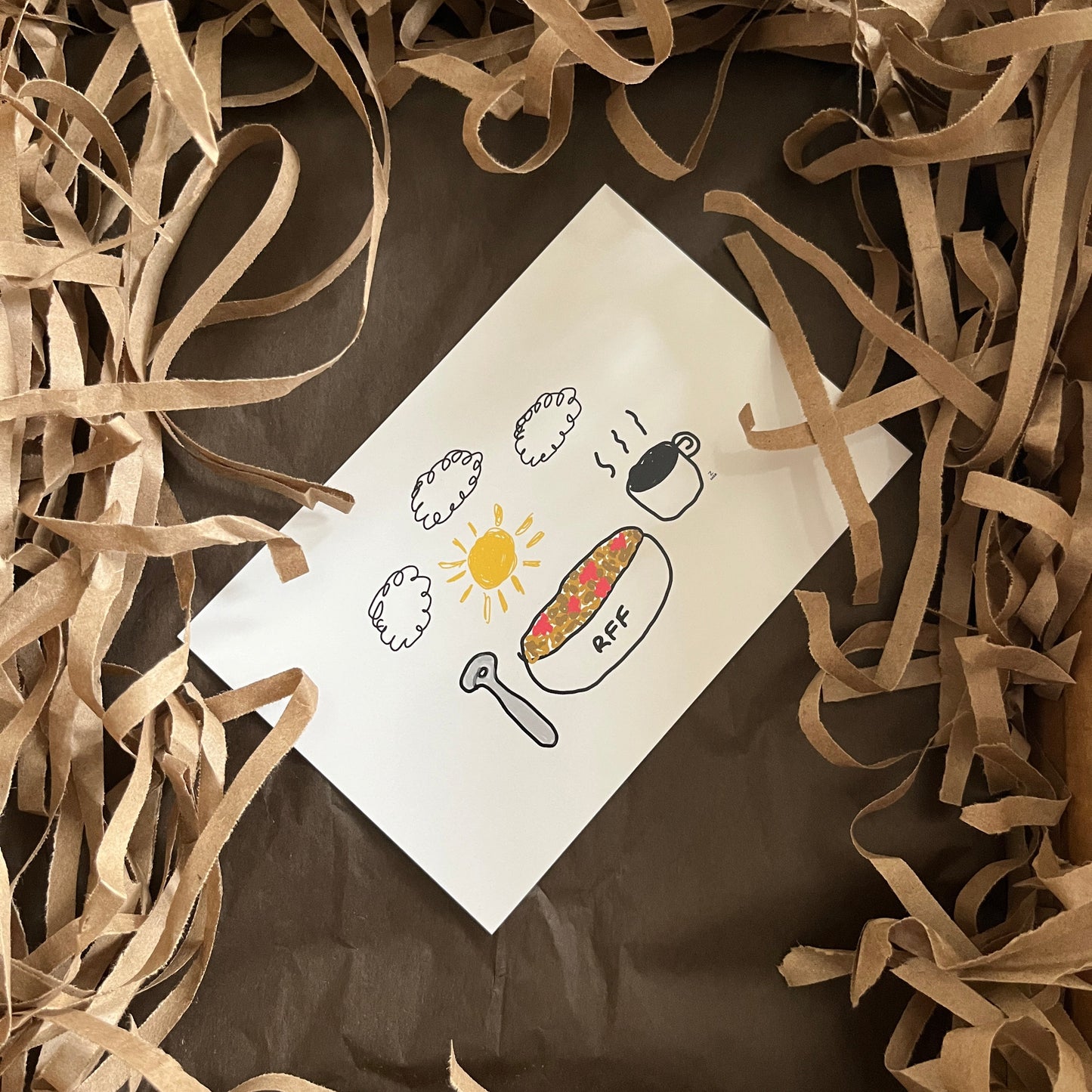 Card with illustrations surrounded by brown paper