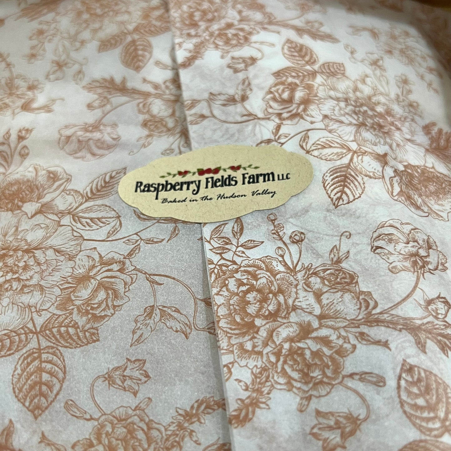Floral patterned tissue paper with a label on a brown background