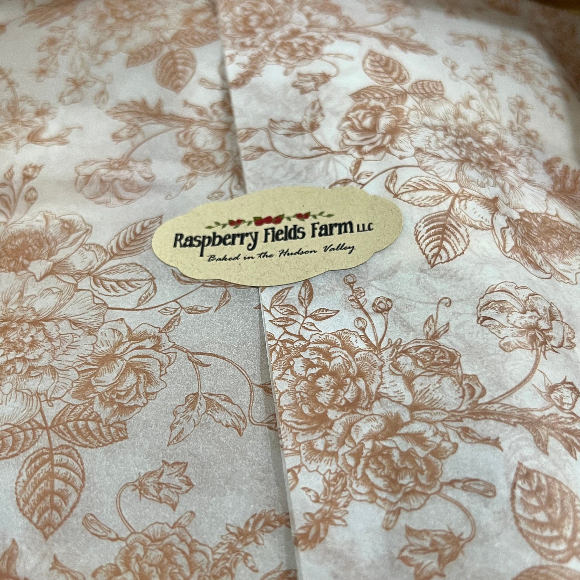 Floral patterned tissue paper with a label on a brown background